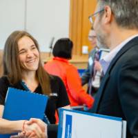 A man and a woman shaking hands.